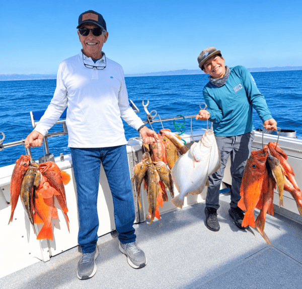 Two anglers with their catch of fish on a boat in Monterey Bay.
